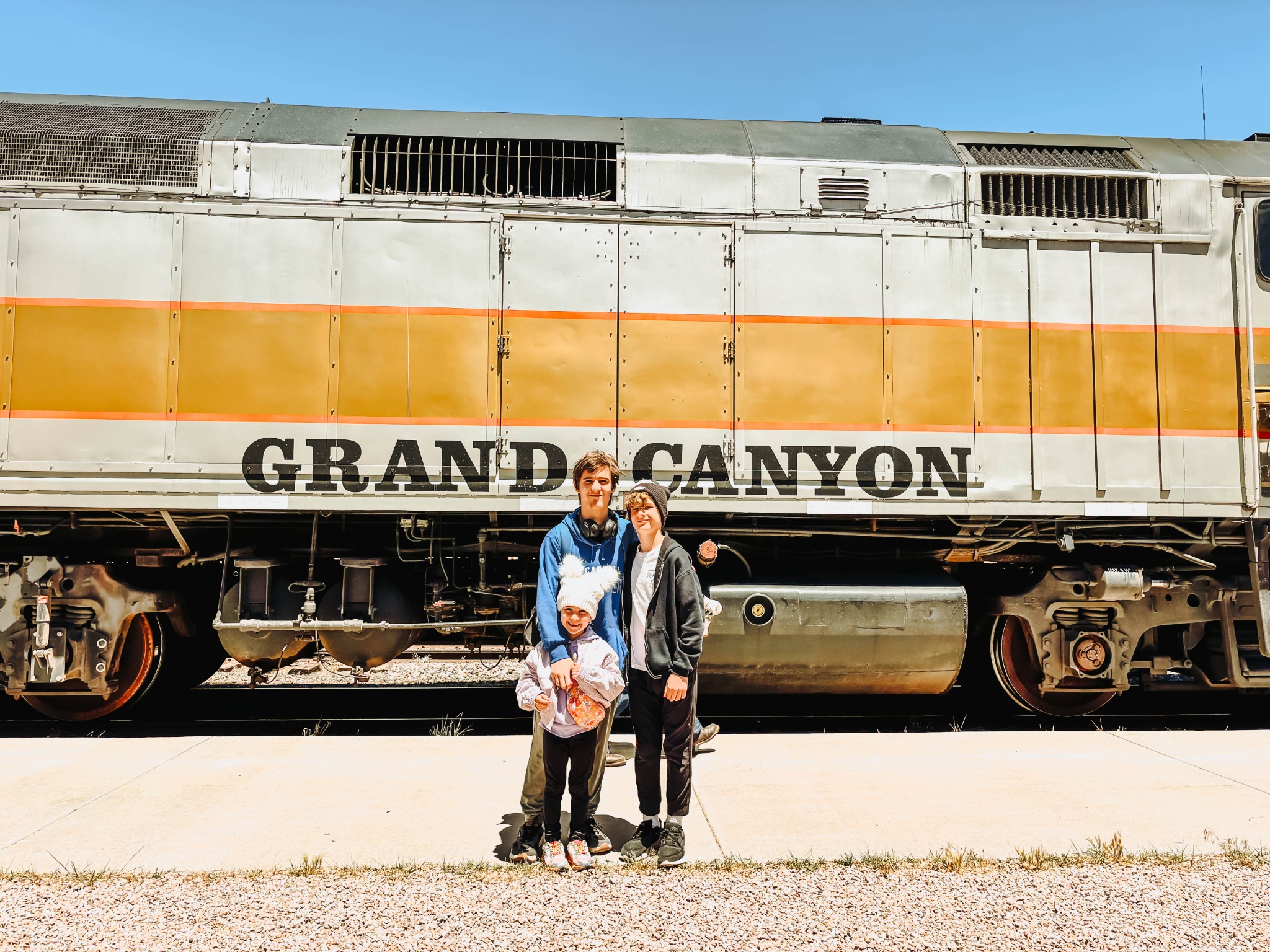 Children standing in front of the Grand Canyon Railway train in Williams, Arizona