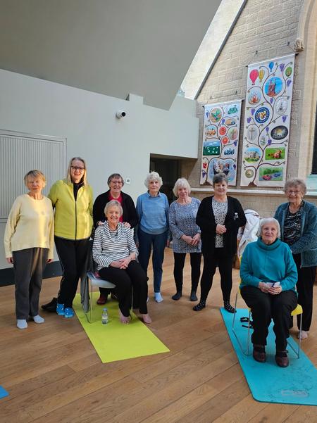 A friendly group of senior students at a Daisy Chain Chair Yoga class in Manthorpe Church Hall, Grantham.