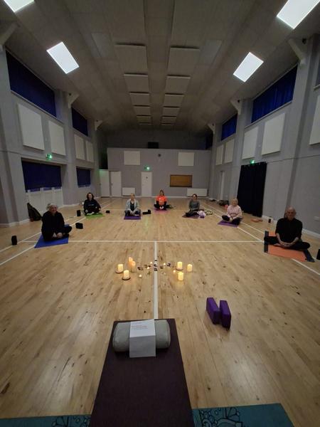Daisychain Yoga class in South Lincolnshire, group yoga session in a community hall with mats, candles and props, focused on relaxation, flexibility and wellbeing.