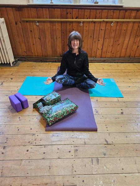 Rachel Metcalfe of Daisy Chain Yoga practicing meditation in a traditional village hall in South Lincolnshire.