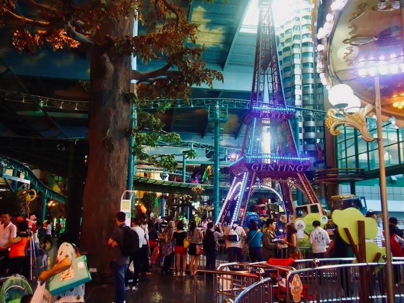 Illuminated replica Eiffel Tower inside Genting Highlands hotel with crowds below