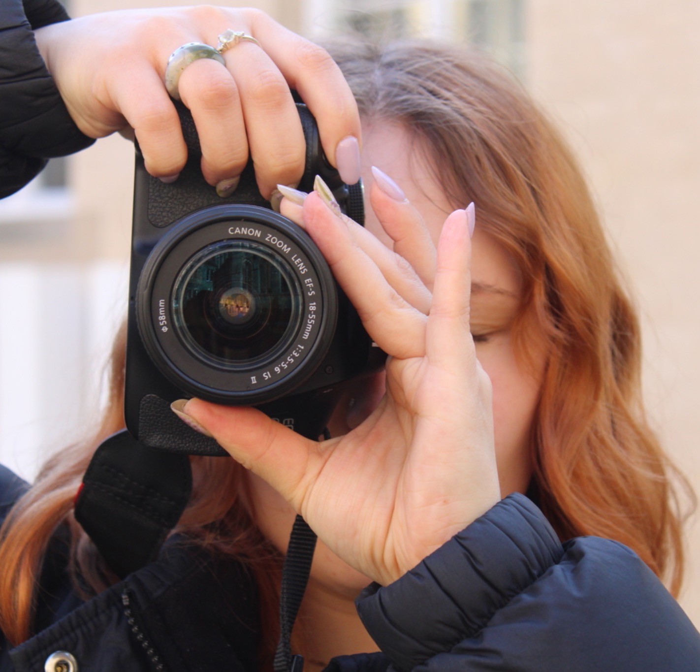 Photographer and broadcast journalism graduate Lily Baldwin with a camera.