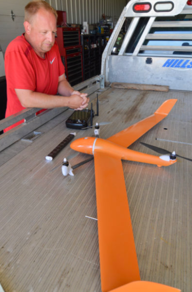 farmer prepares to fly drone farmer prepares to fly drone