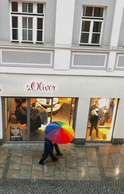 overhead rainy street view of unbrella