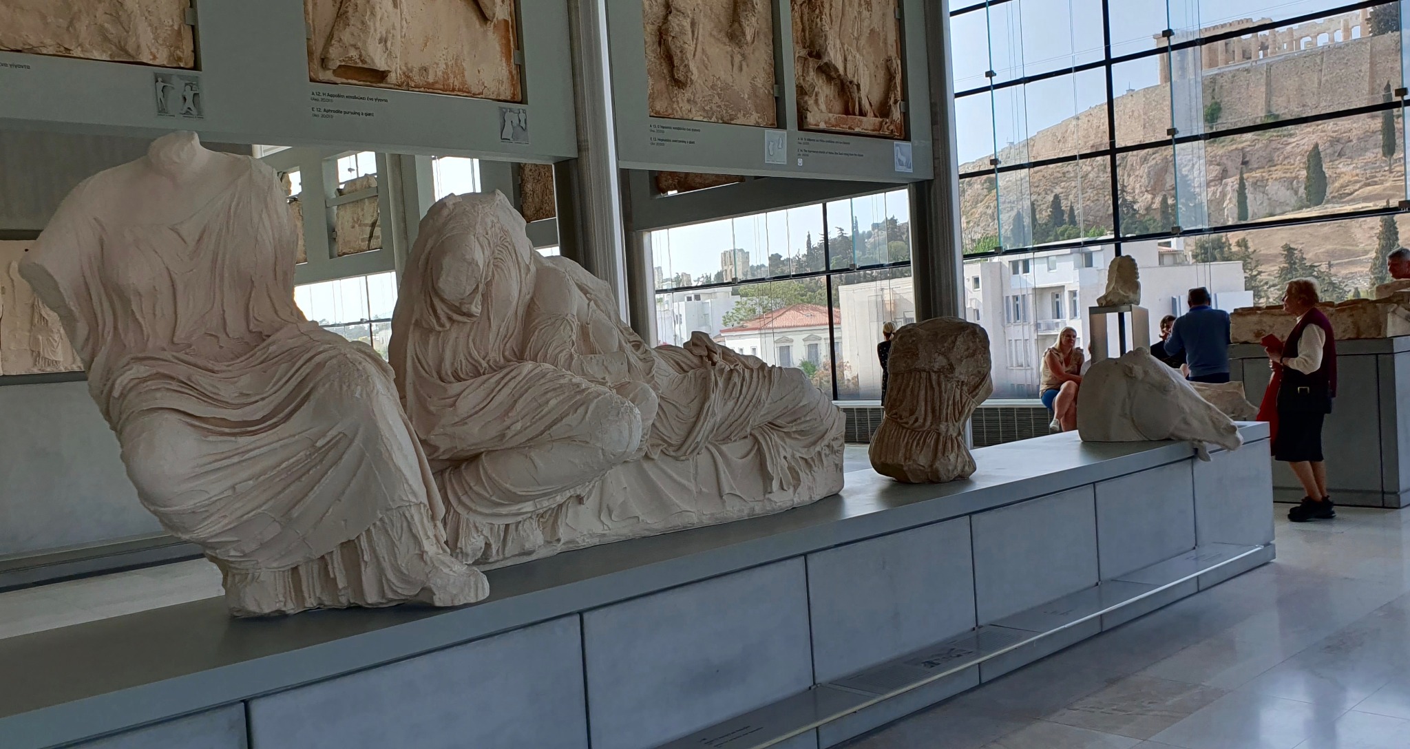 The Acropolis Museum in Athens, with the Parthenon visible on the Acropolis through the gallery’s large windows.