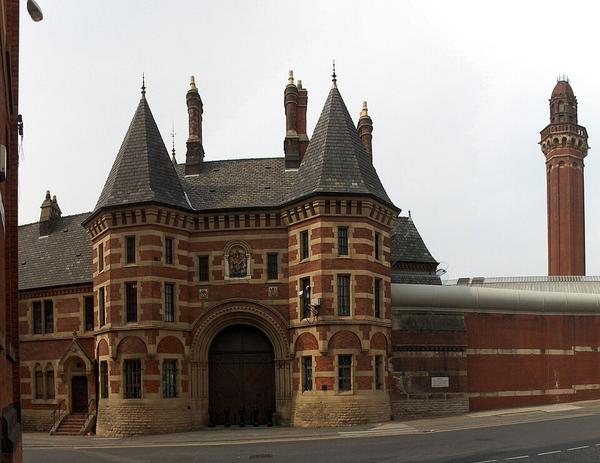 The Victorian red-brick entrance and walls of HMP Manchester, commonly known as Strangeways.