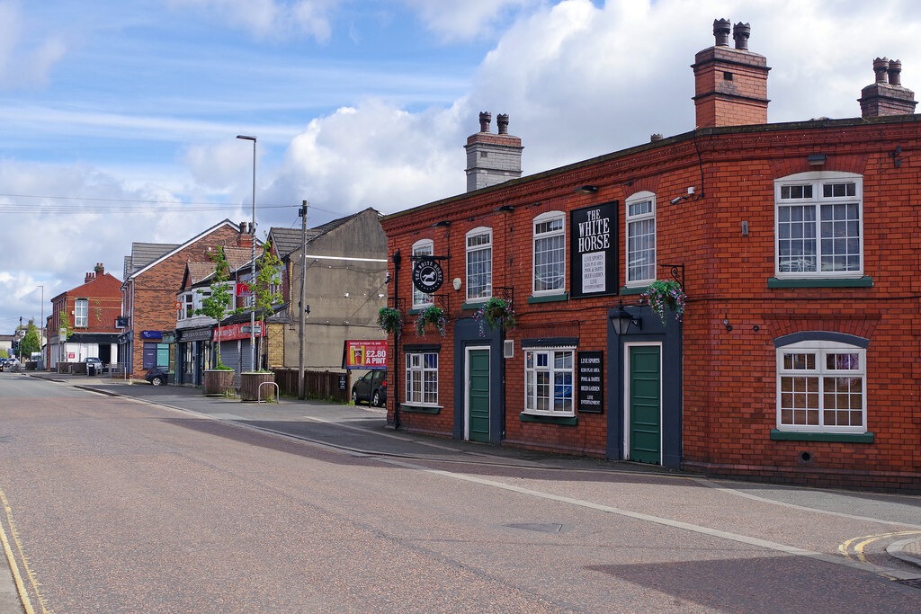 Liverpool Road through Irlam, where local shops and places to eat form part of the everyday geography of the town.