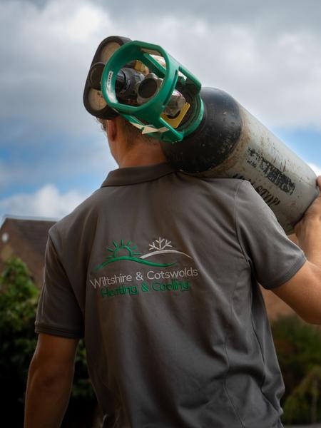 Engineer checking refrigerant gas during AC installation. Photographed by Lowes Creative Media