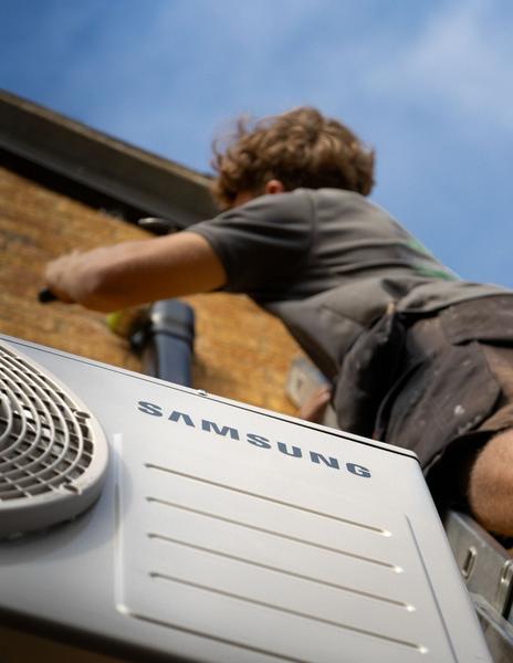Samsung AC unit with Wiltshire & Cotswold Heating and Cooling employee. Photographed by Lowes Creative Media