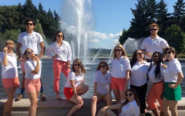 Staff poses for picture in front of water fountain