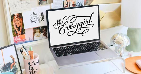 Laptop sitting on a desk with a background from The Everygirl Laptop sitting on a desk with a background from The Everygirl